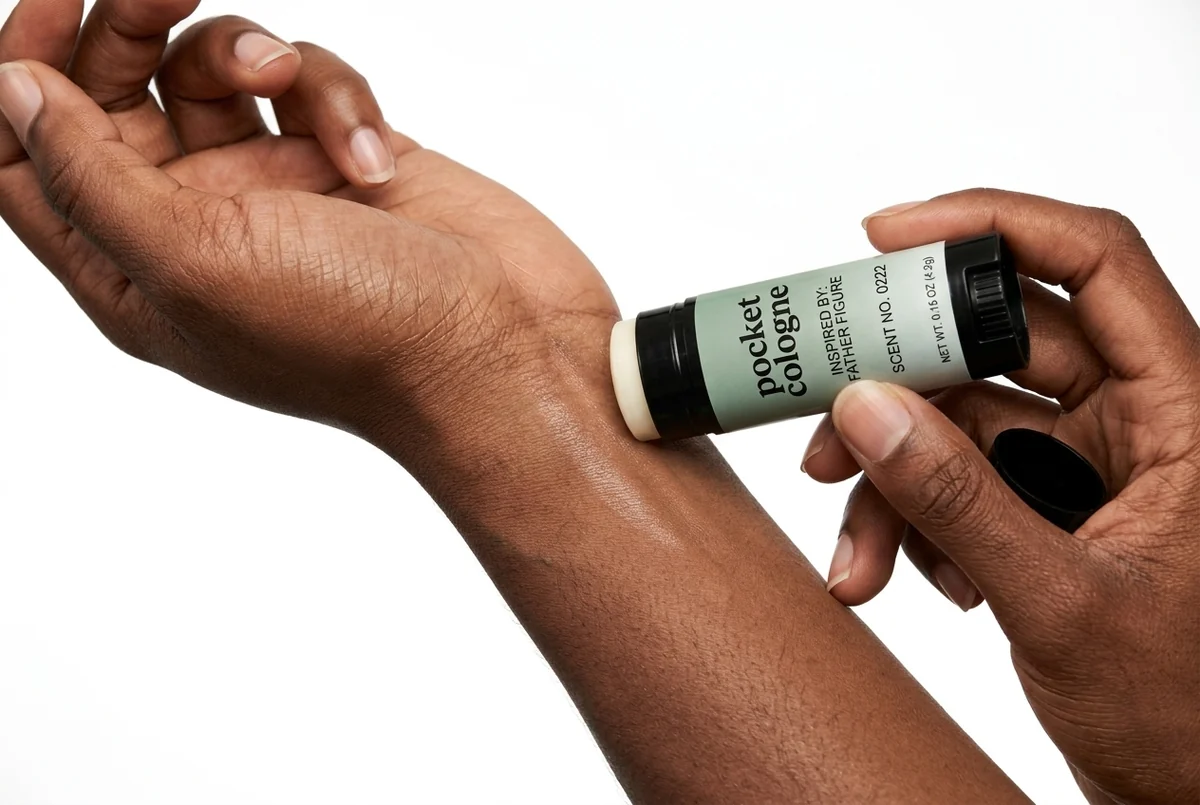 Applying Pocket Cologne Scent No. 0013, inspired by Sauvage, to the back of the hand